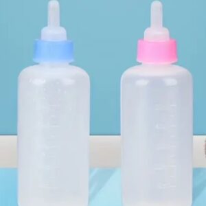 Two empty baby bottles with blue and pink caps.