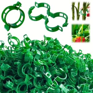 Green plastic plant support clips for gardening and plant training.
