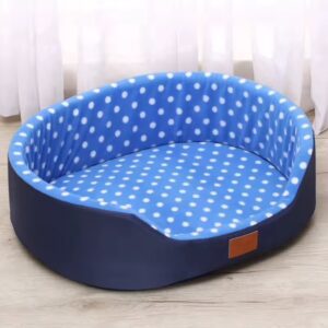 Blue pet bed with white polka dots and a curved backrest.